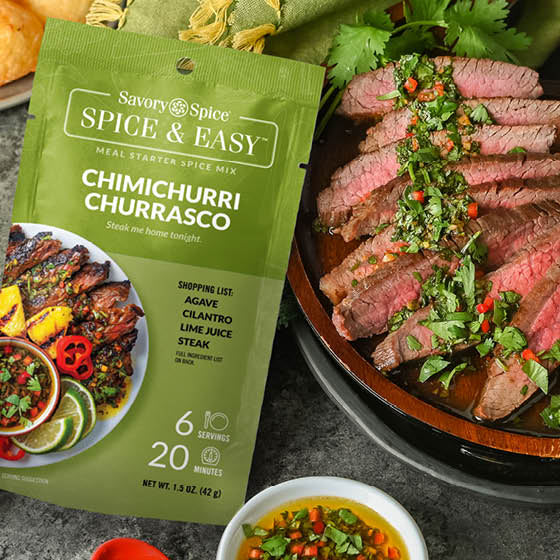 Chimichurri Churrasco Spice & Easy Meal Starter Spice Mix with finished steak dish, garnishes, and Brazilian cheese puffs